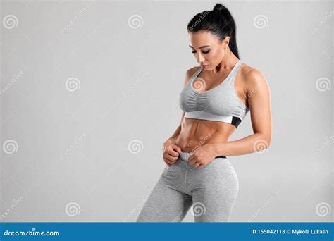 Fitness Woman Showing Abs And Flat Belly On Gray Background Beautiful