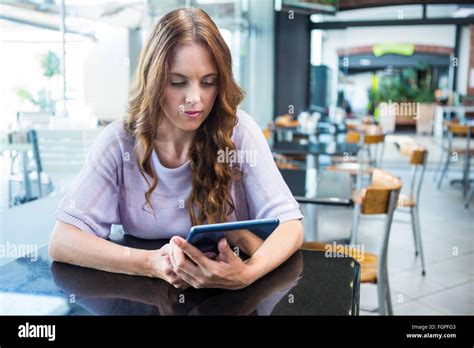 Pretty Brunette Using Her Tablet Stock Photo Alamy