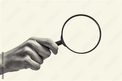 Female Hand Holding The Magnifying Glass On Isolated Background Black