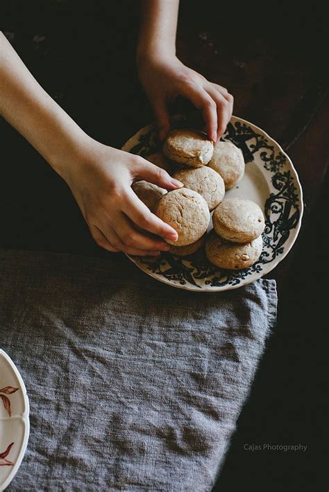 A Person Is Holding Some Cookies On A Plate