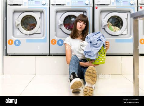 Serious Woman Holding Laundry Basket Stock Photo Alamy