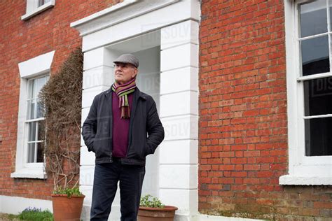 Senior Man Standing Outside Front Door Of House Stock Photo Dissolve