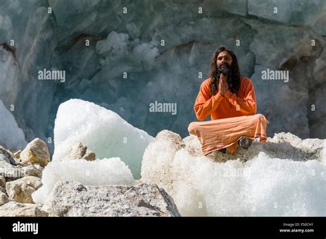 A Sadhu Holy Man Is Sitting And Praying In Lotus Pose Padmasana On