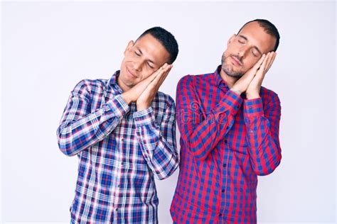 Young Gay Couple Of Two Men Wearing Casual Clothes Sleeping Tired