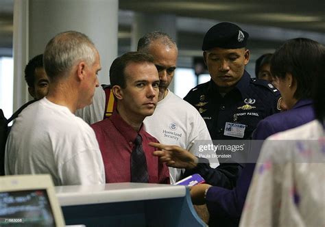 American John Mark Karr is escorted by U.S. security officials as he ...