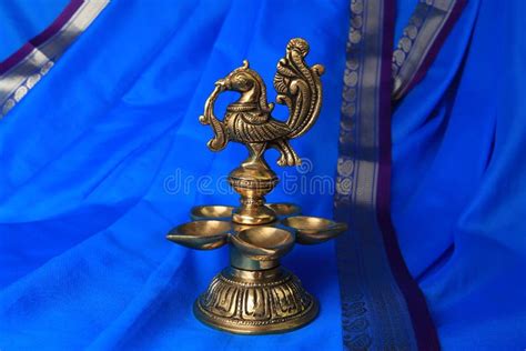 Indian Traditional Bronze Oil Lamp In The Form Of A Bird On A Blue Sari