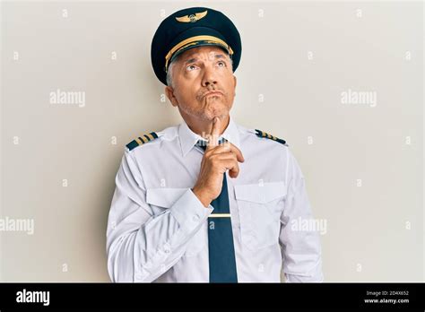 Handsome Middle Age Mature Man Wearing Airplane Pilot Uniform Thinking Concentrated About Doubt