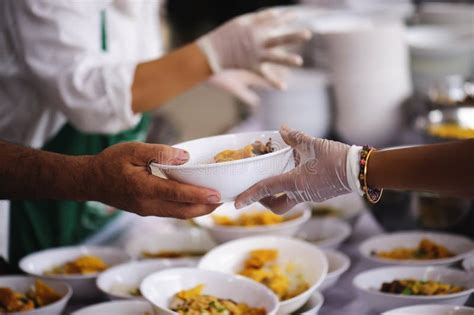 Volunteers Share Food To The Poor To Relieve Hunger Charity Concept