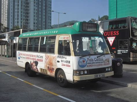 A Bus That Is Sitting In The Street Next To Some Other Buses And