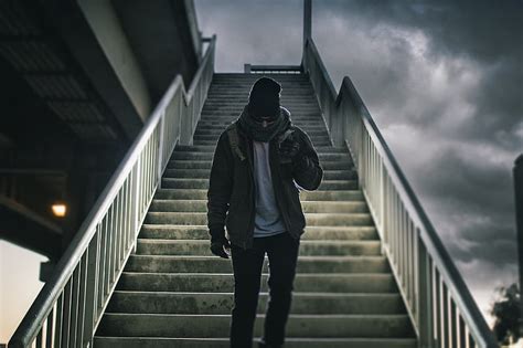 Man Wearing Brown Jacket Walking On The Stair Under Black Sky HD