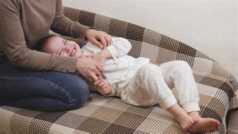 The Girl Plays With Her Mother In The Childrenand X27s Room On The Sofa