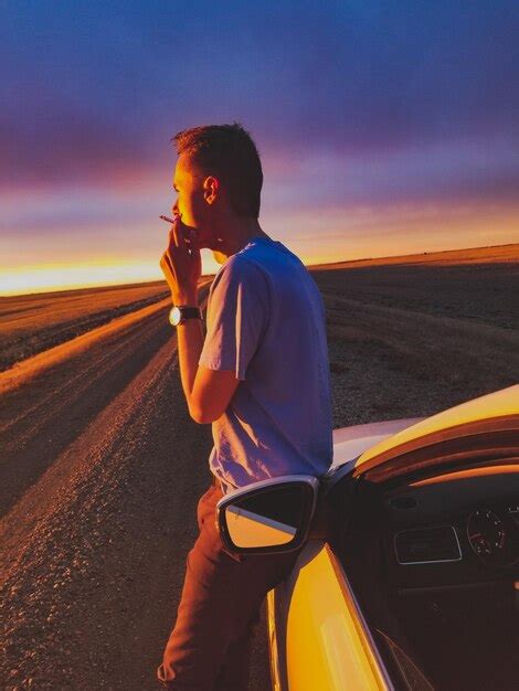 Premium Photo Side View Of Man Smoking Cigarette While Standing By