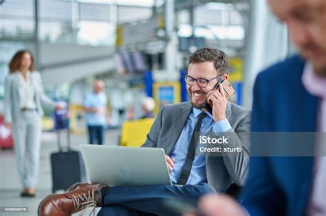 Businessman Using Laptop In Airport Lounge Stock Photo Download Image