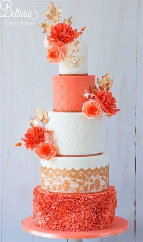 A Three Tiered Cake With Orange Flowers On Top