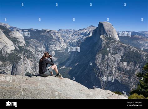 Woman Photographs The Half Dome In Summer With A Blue Sky Yosemite