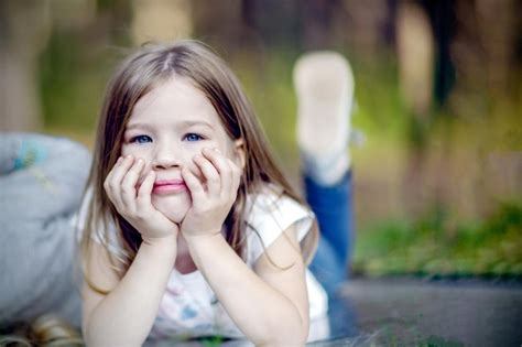 Premium Photo Child Lying On The Grass In The Park