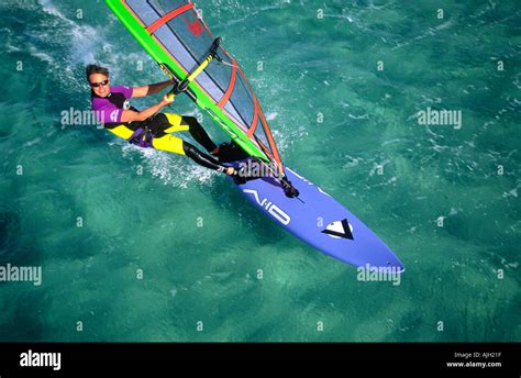 Aerial Of Male Windsurfer Sailing On Emerald Green Water Of Red Sea