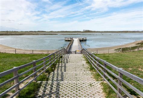 Knokke Heist Flemish Region Belgium Active Woman Walking Down A Wooden Pier In A Coastside