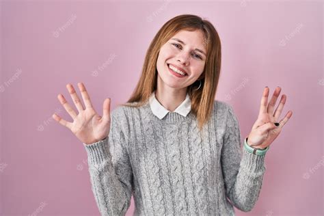 Premium Photo Beautiful Woman Standing Over Pink Background Showing