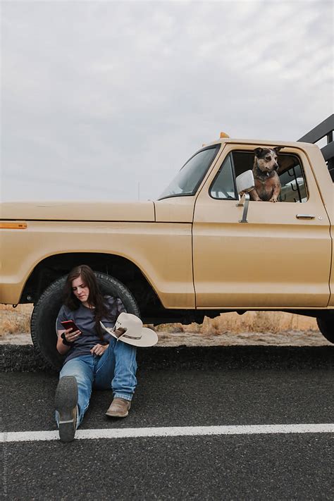 Cowgirl Leaning Against Pickup Park Along Road By Stocksy Contributor Tana Teel Stocksy