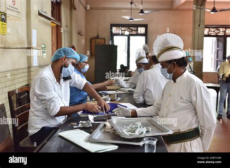 Waiters Wearing Protective Face Maskd At Work In A Coffee House In