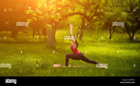 Woman practicing high lunge yoga pose Stock Photo - Alamy