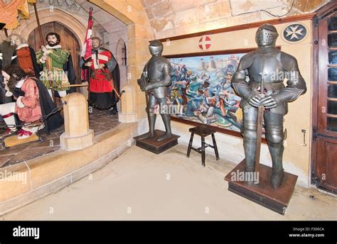 Knights in full armor on display inside a museum building in Mdina ...