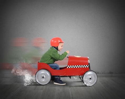 Premium Photo Side View Of Man Sitting In Toy Car Against Wall