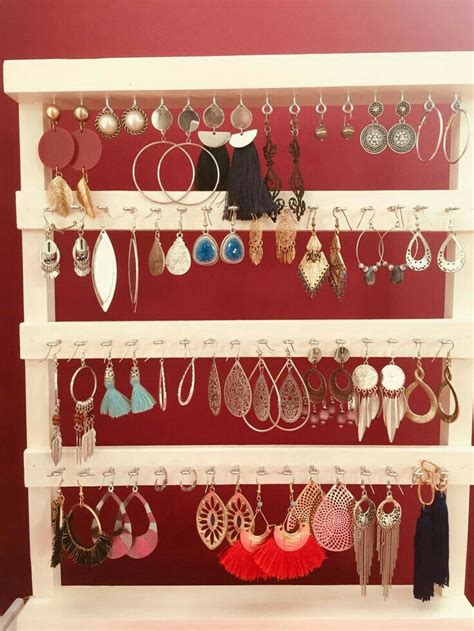 A White Shelf With Lots Of Earrings On It