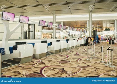 The Public Check In Area Of An Airport With Crowd Control Barriers