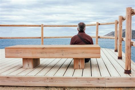 Premium Photo A Seated Man Contemplates The Sea