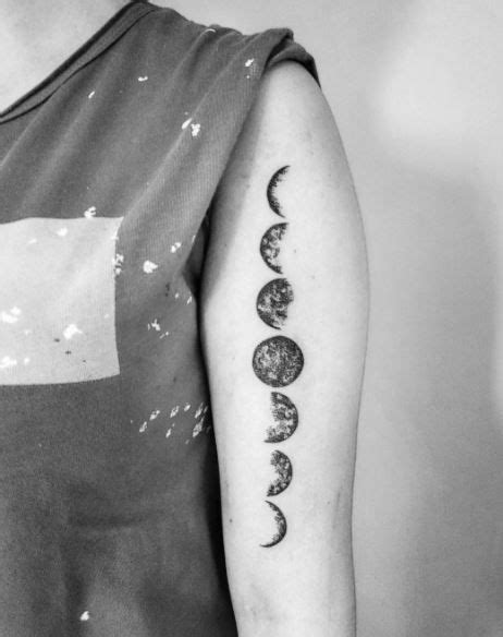 A Woman With A Tattoo On Her Arm Showing Phases Of The Moon