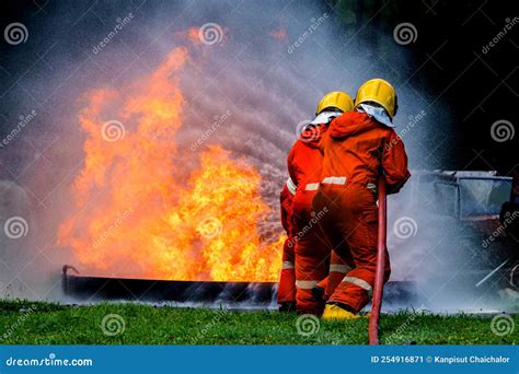 Firefighter Concept Fireman Using Water And Extinguisher To Fighting