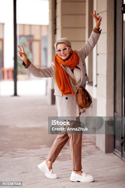 Funny Excited Mature Woman Shows Victory Gesture Has Fun Smiles Wears