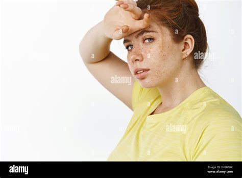 Portrait Of Chubby Redhead Woman Wiping Sweat Off Forehead Tired After