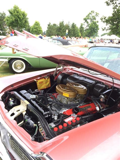 An Old Red Car With The Hood Open And Its Engine In It S Trunk