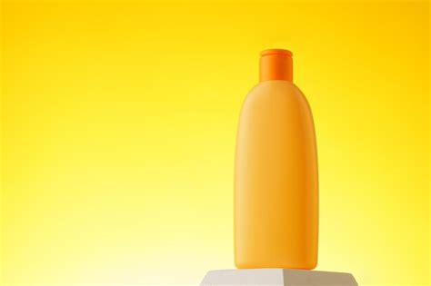 Premium Photo Cosmetic Bottle With Sunscreen Lotion On Yellow Background