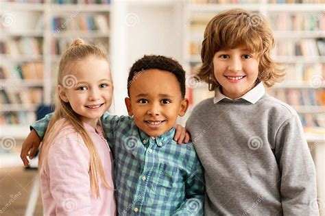 Portrait Of Happy Multiracial Primary School Classmates Embracing And