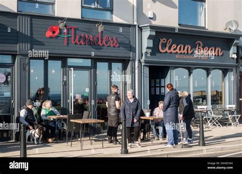 People Sitting Outside A Café On Seaham Seafront In Co Durham England