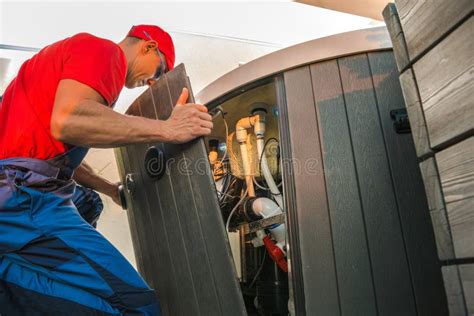 Technician Servicing Hot Tub Equipment At Residential Location During