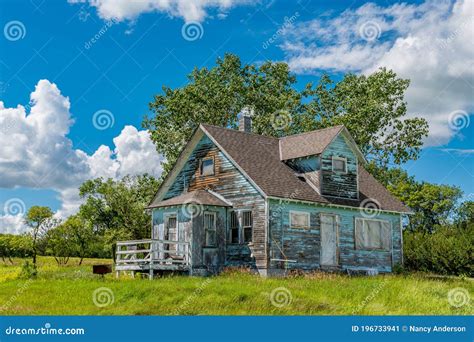 Old Abandoned Blue Prairie Farmhouse In The Ghost Town Of Kayville