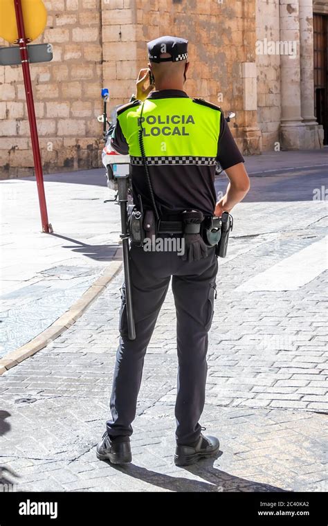 Back view of Spanish police with "Local Police" logo emblem on uniform ...