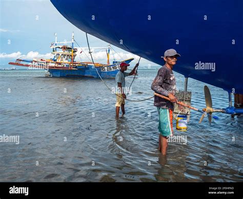 Maintenance Work Being Done On A Traditional Fishing Boat With