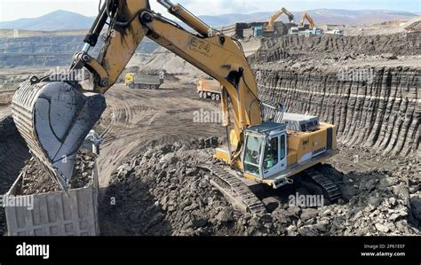 Excavators Working On Huge Mining Site Loading The Trucks Trucks