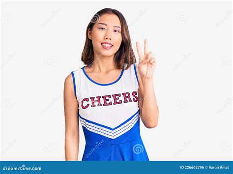 Young Beautiful Chinese Girl Wearing Cheerleader Uniform Showing And