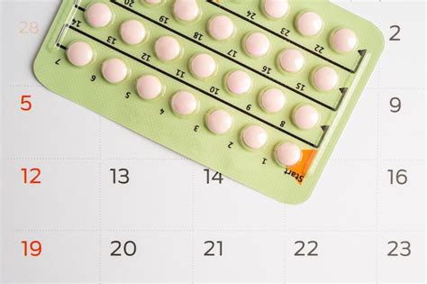 Premium Photo Pregnancy Test And Birth Control Pills On Calendar Contraception Health And Medicine