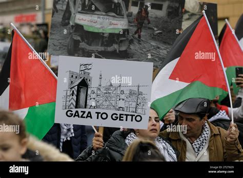 A Woman Holds A Placard Saying Gaza Is A Ghetto During The March Of