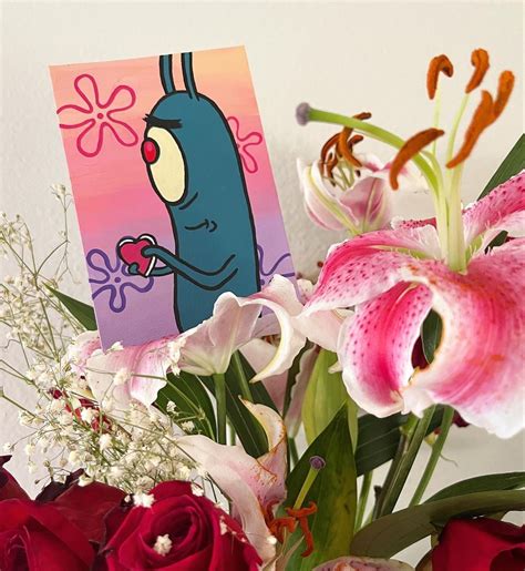 A Vase Filled With Flowers Next To A Card