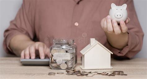 A Man Is Calculating Money To Save And Puts It In A Piggy Bank Ideas