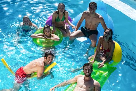 Premium Photo Group Of Friends Having Fun In Swimming Pool